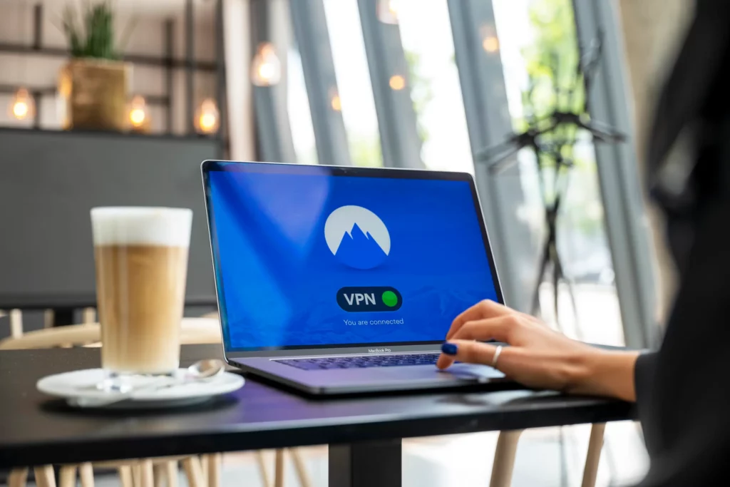 woman using a laptop with nordvpn in a cafe